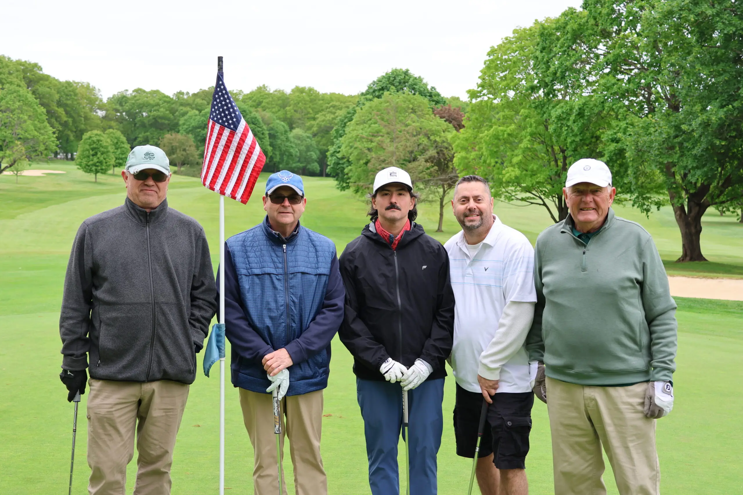 PGA standing in front of american flag